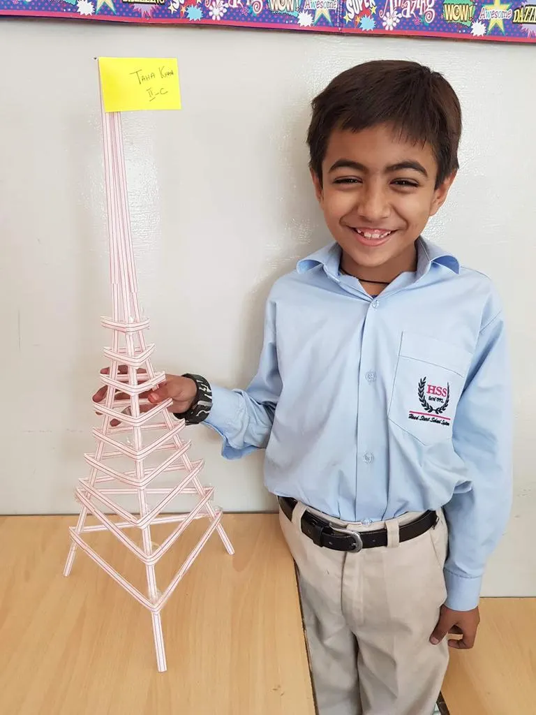 Student showcasing structural tower engineering project